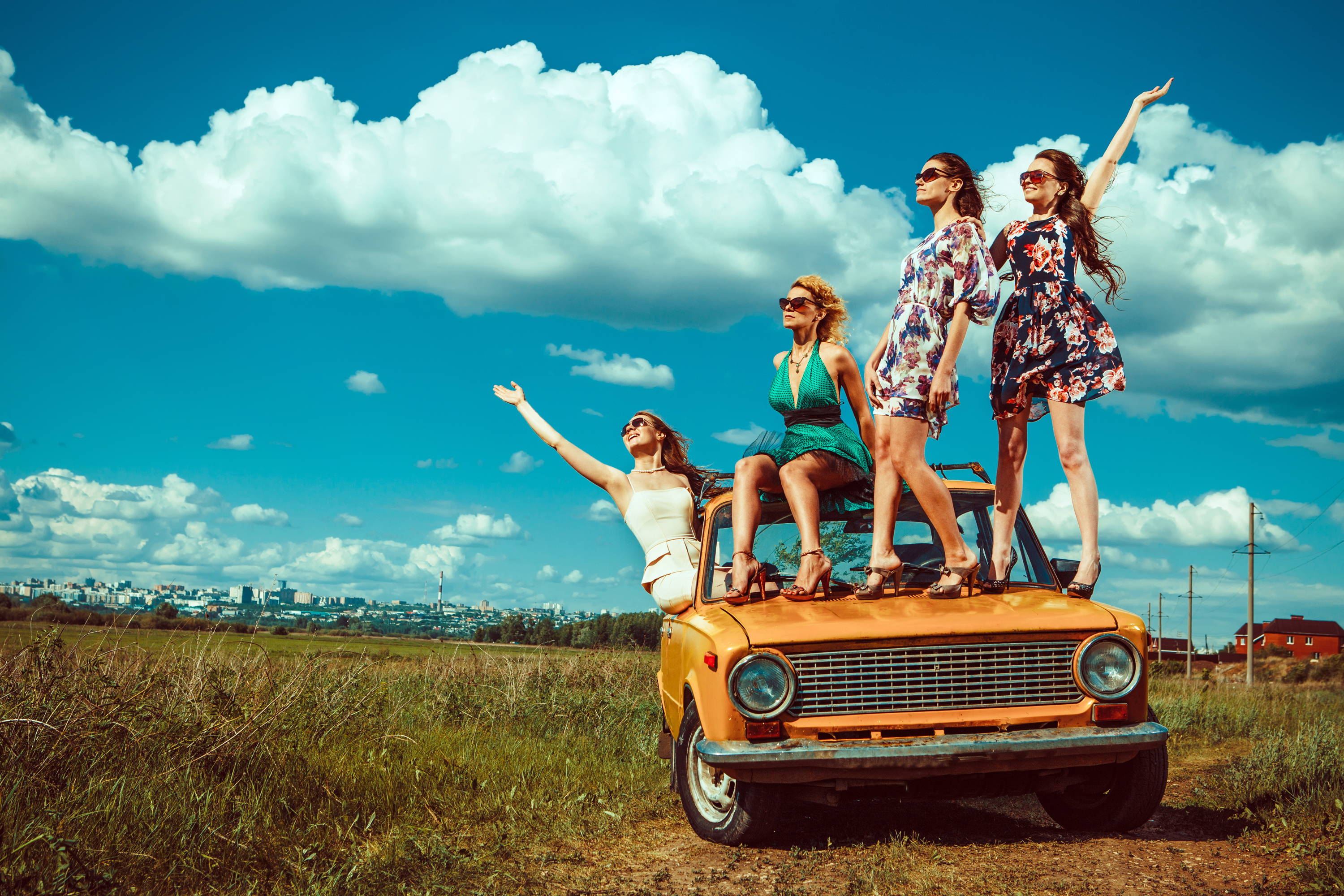 women celebrating their labor day off outdoors as their healthy hair flies in the wind. 