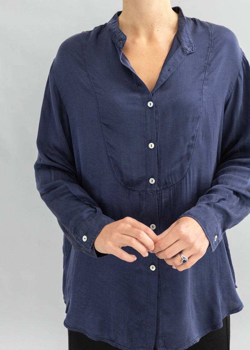 A model wearing a dark blue silk shirt