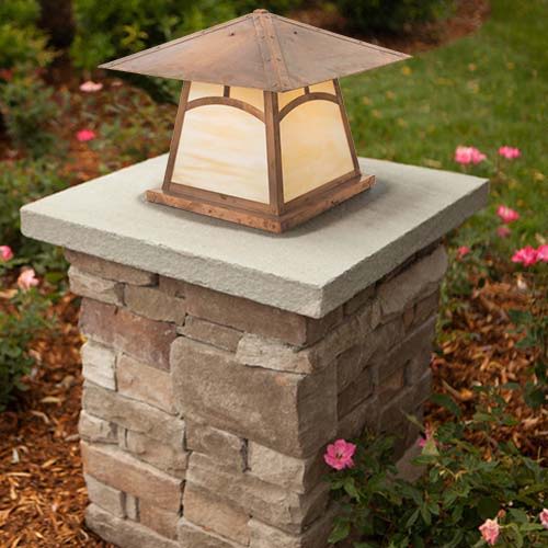 A tapered Craftsman column light with mottling on the raw copper finish.