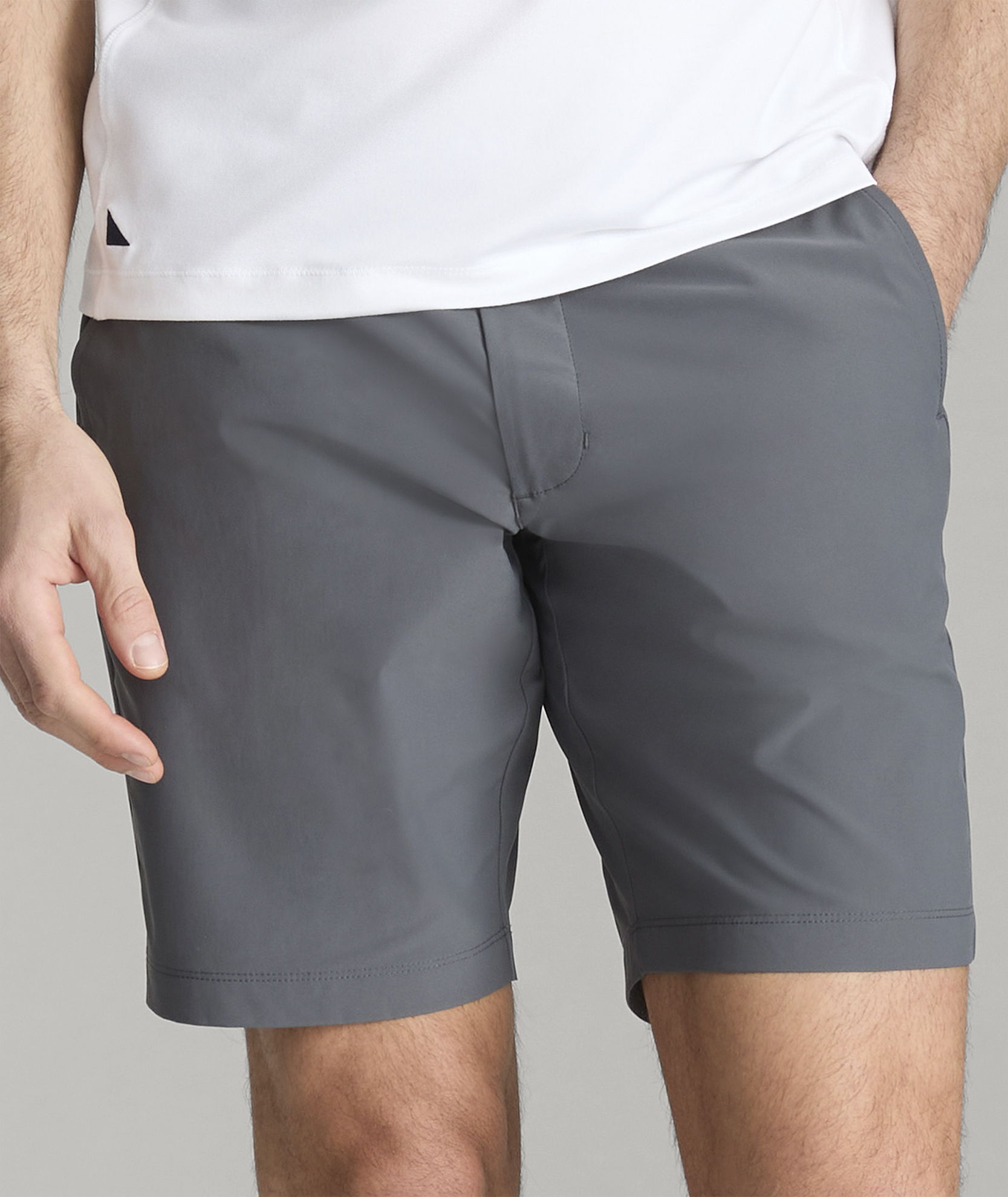 A person wearing gray shorts and a white shirt.