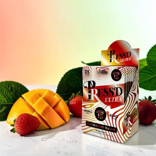 Box of Pressed Ultra juice with mango and strawberries on a colorful background.