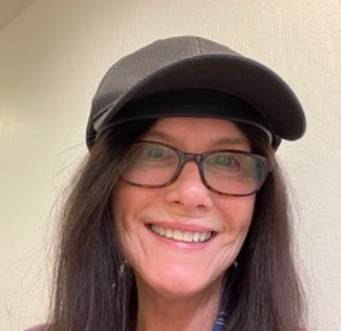 woman smiling while wearing illumiflow 272 pro under a cap