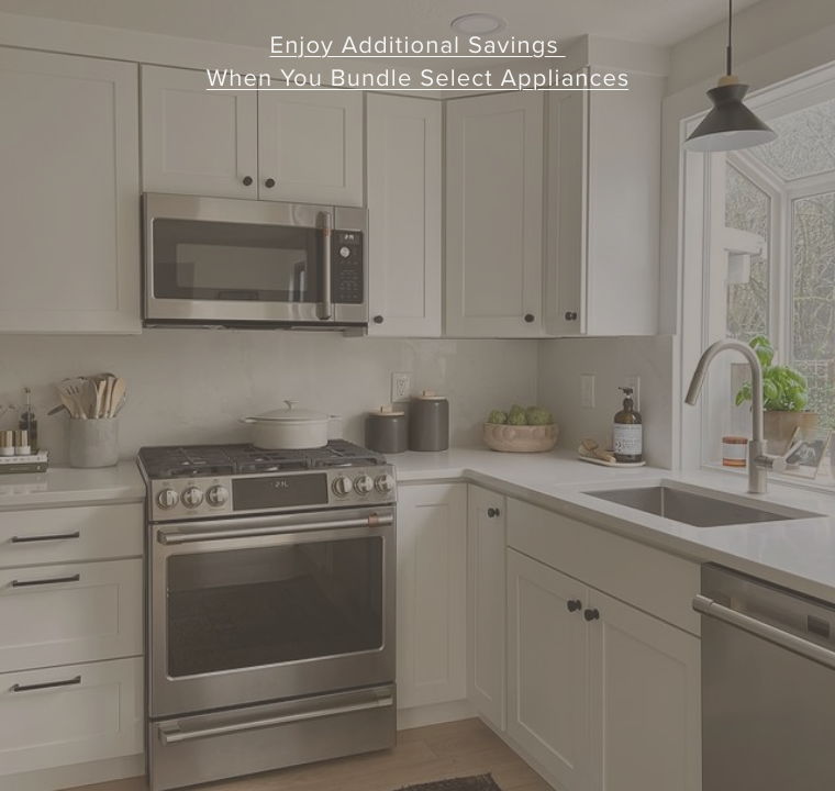 Modern kitchen with stainless steel appliances and natural light from a window.