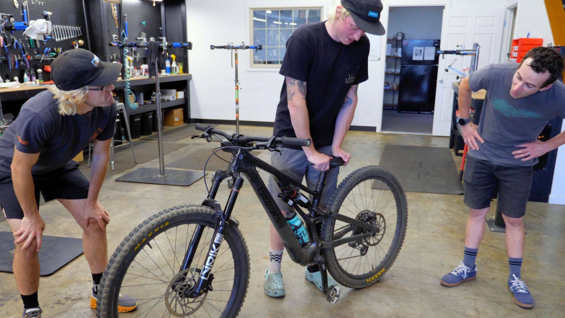 bike shop employees compressing rockshox vivid ultimate