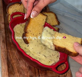 Bread slices dipped into a spinach dip with the text 