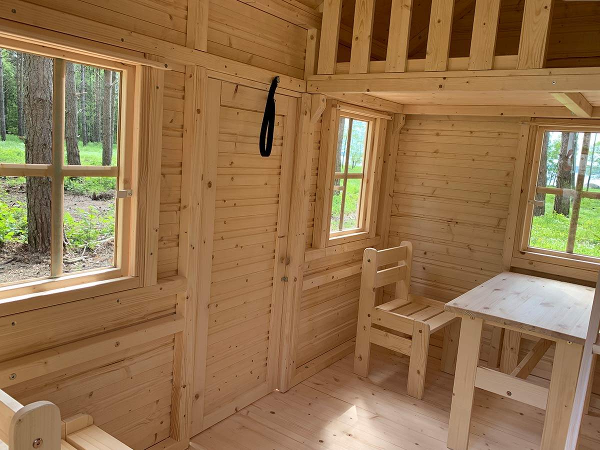 Inside view of Wooden Playhouse with loft and kids furniture by WholeWoodPlayhouses