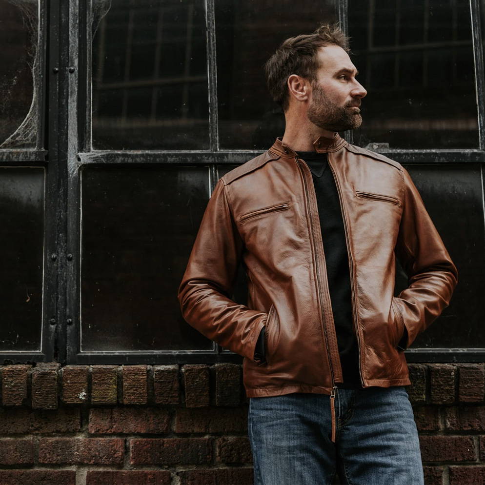 man with a leather jacket in a t-shirt and jeans