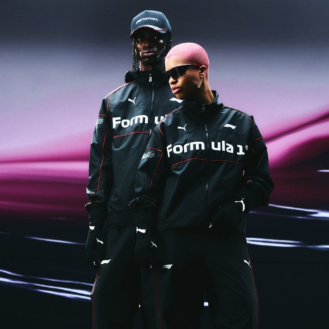 PUMA FORMULA 1 - Two models in black Formula 1 apparel against a gradient background.