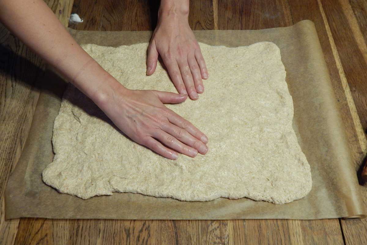 Shaping the dough into a rectangle on a piece of parchment paper