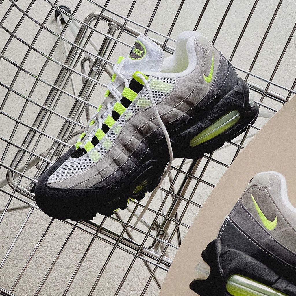 A pair of Nike Air Max shoes on a wire rack.