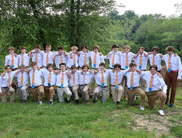 Group of teen boys wearing matching canoe ties with dress shirts and khakis