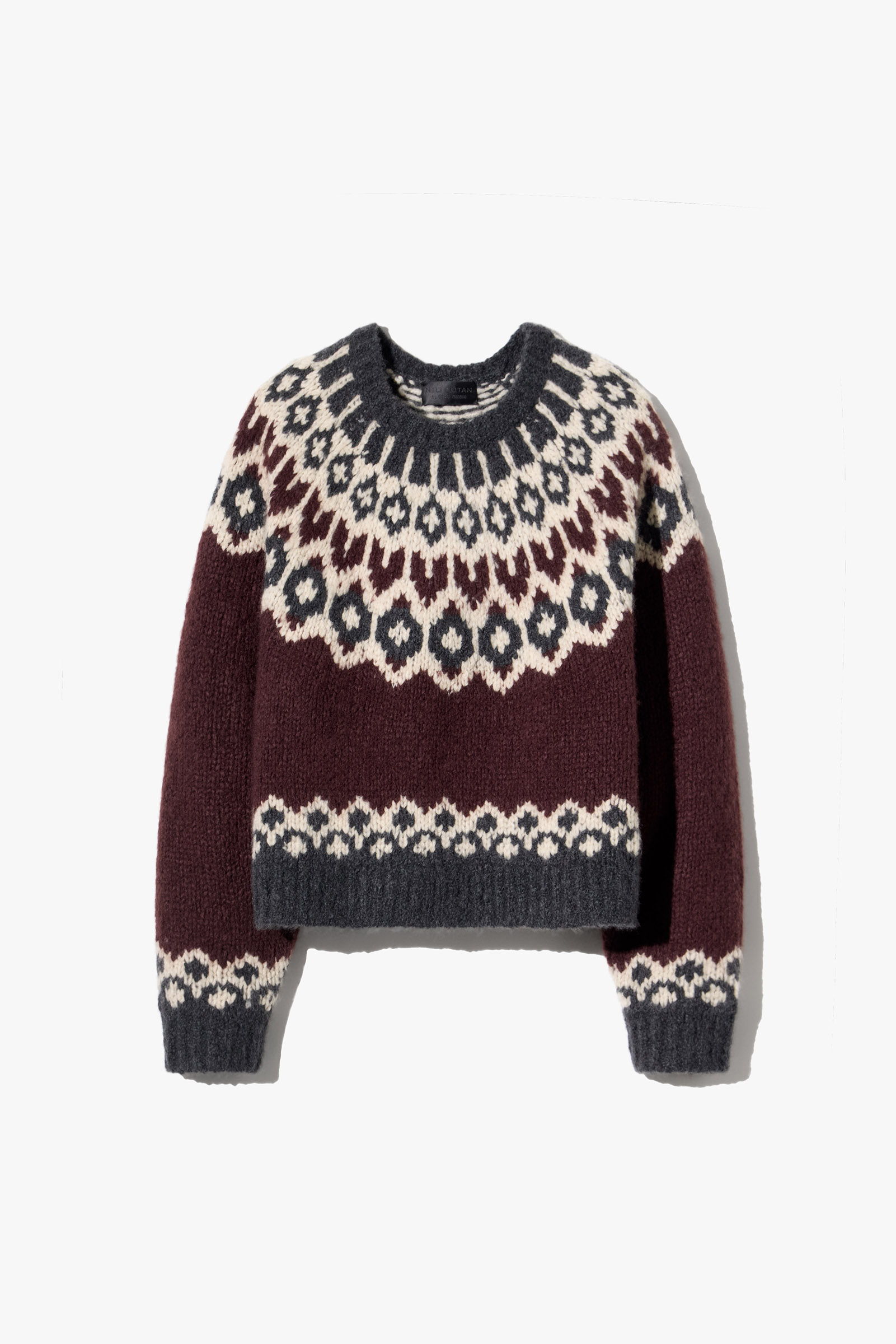 Maroon and cream patterned knitted sweater with a round neckline.