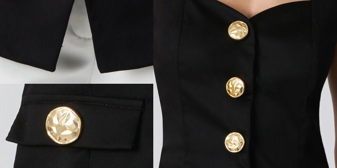 Black outfit details featuring gold buttons and a tailored design.