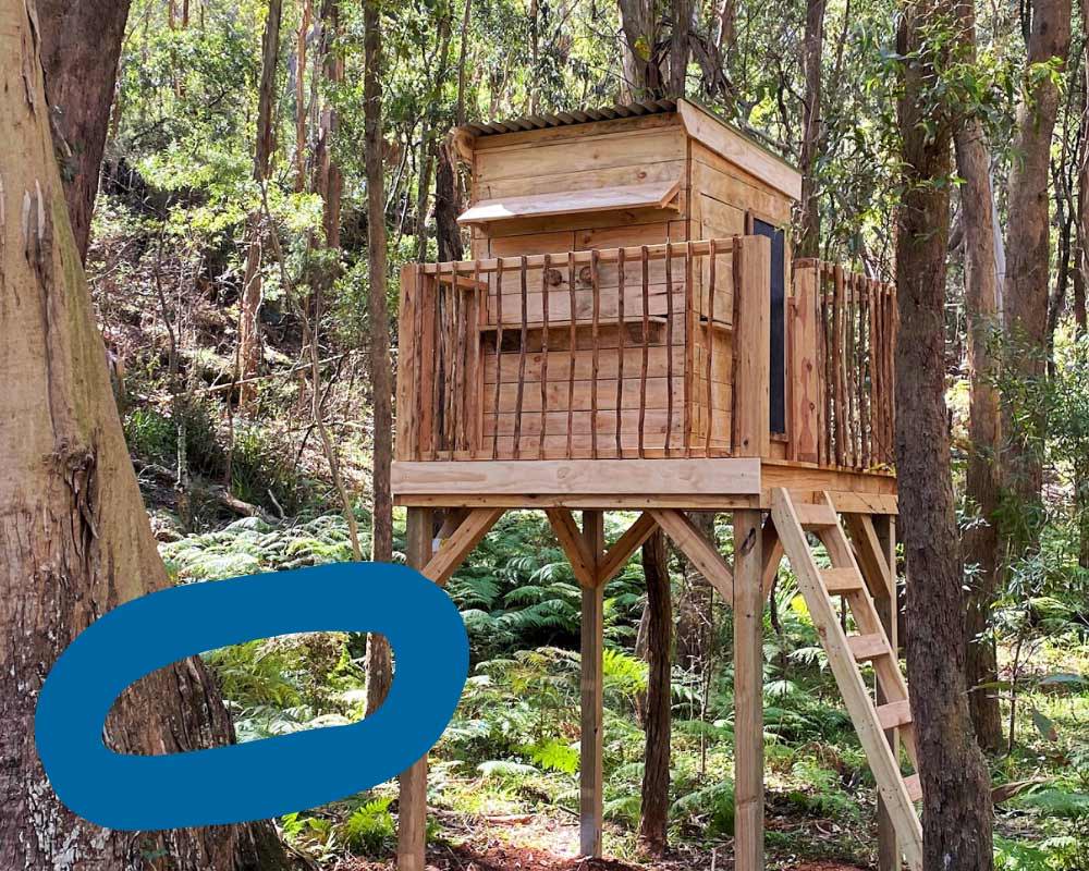 A Wooden Treehouse Cubby House in nature and the woods