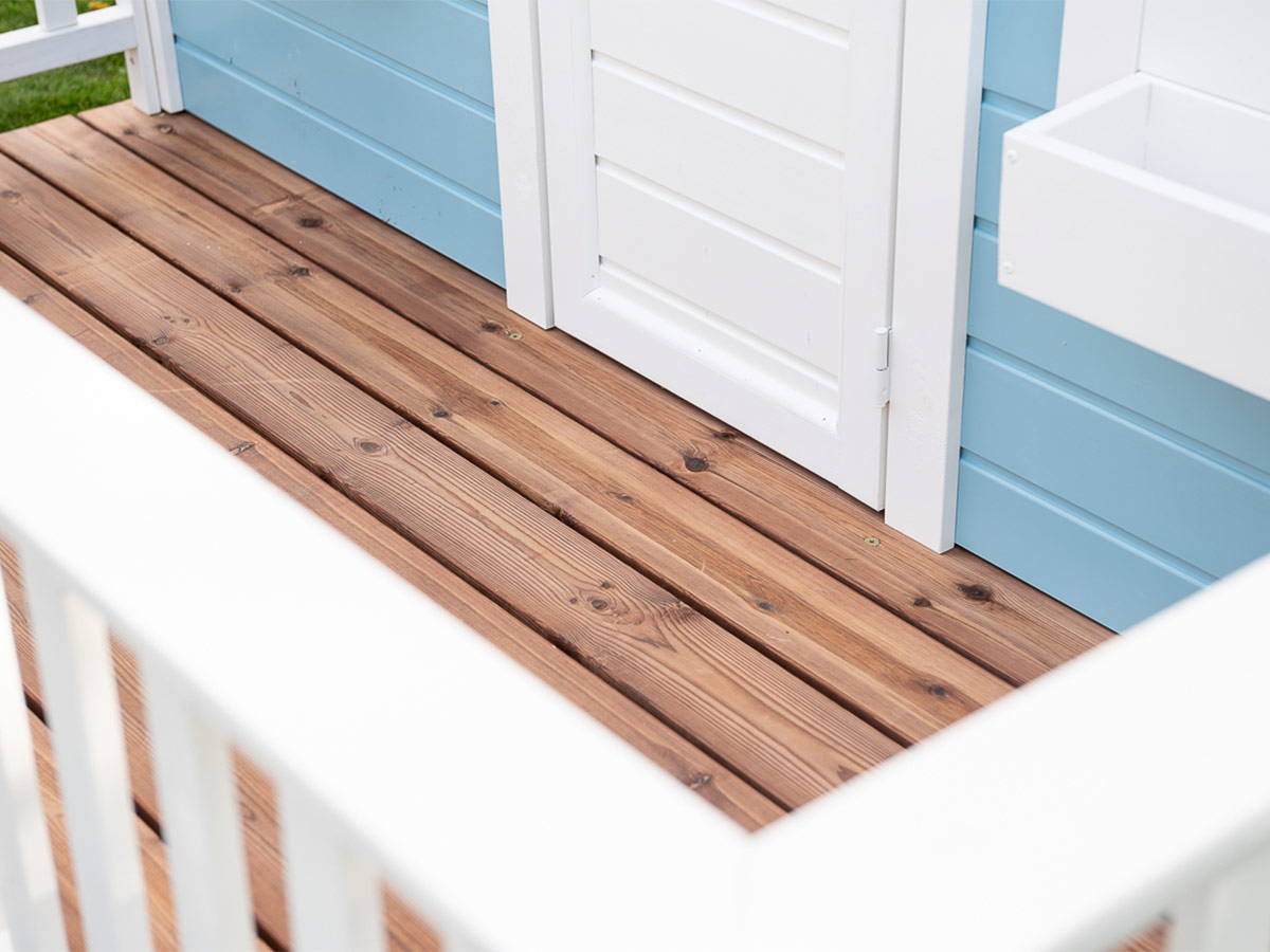 Close Up Of wooden terrace with white railings Of Pre-finished Wooden Playhouse Bluebird By WholeWoodPlayhouses