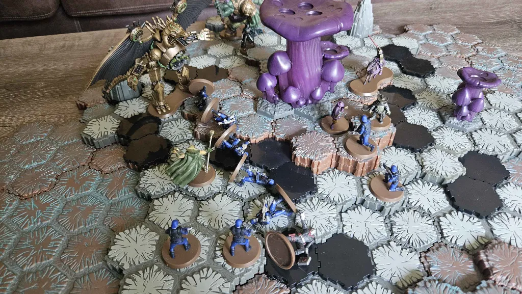 Miniature figures on a hexagonal game board with a purple mushroom.