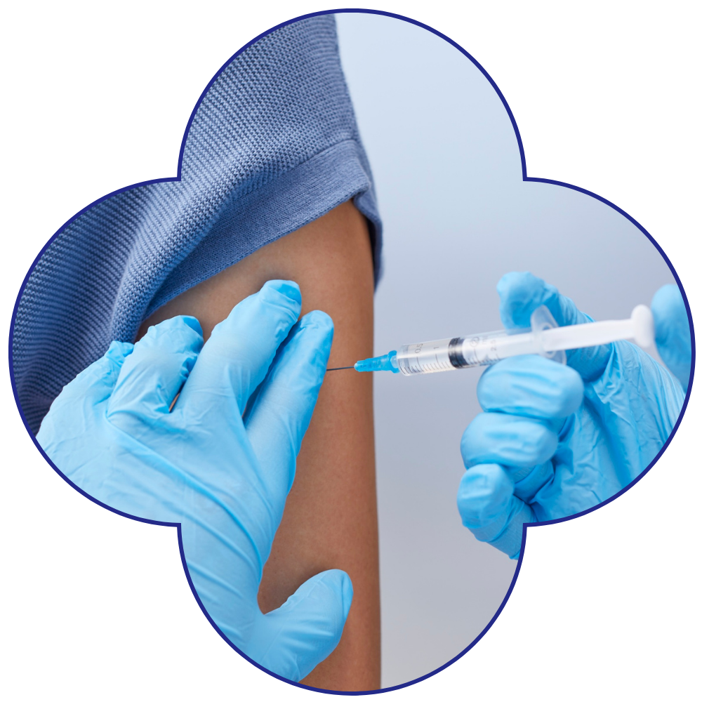 A close-up of a vaccination being administered on an arm.