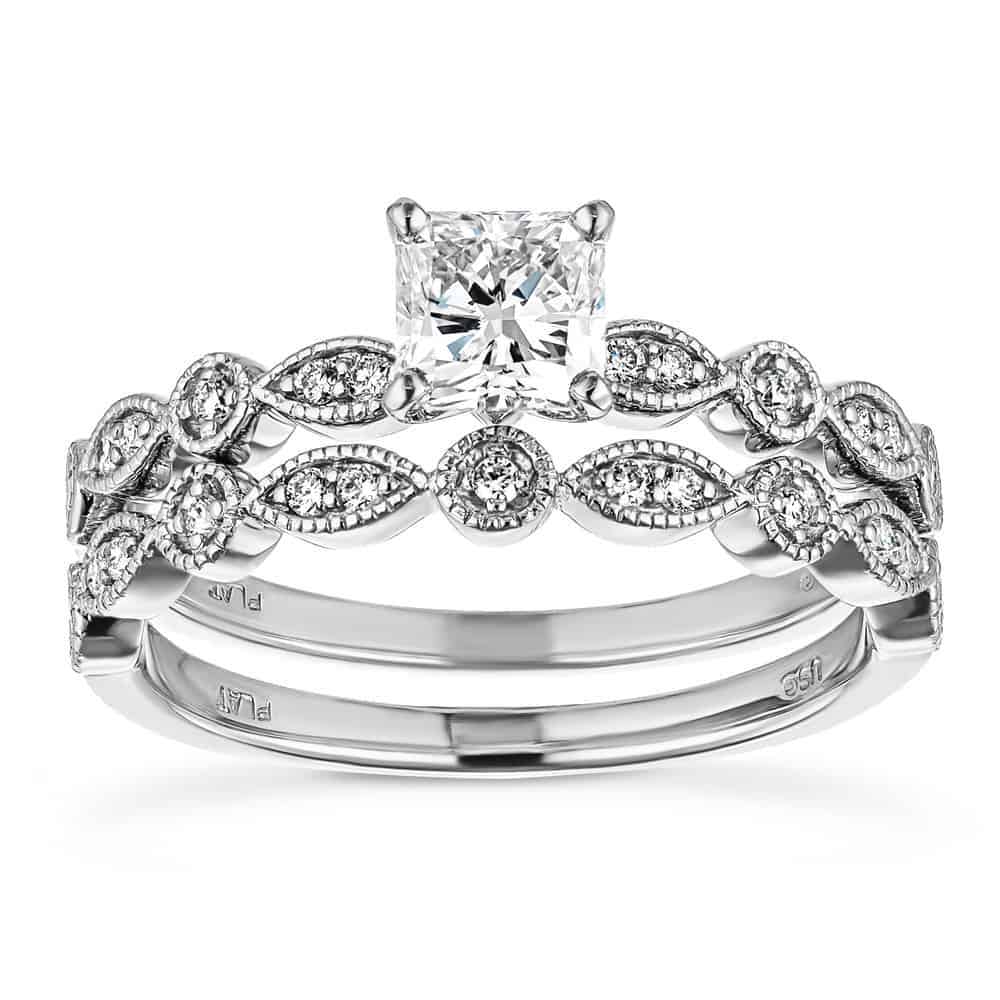 Vintage style wedding ring set with accenting diamonds and a lab grown cushion cut diamond center stone