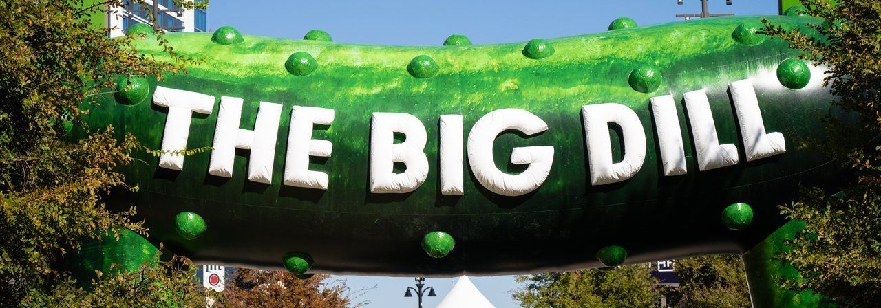 The Big Dill inflatable pickle entrance arch welcoming guests to the pickle festival