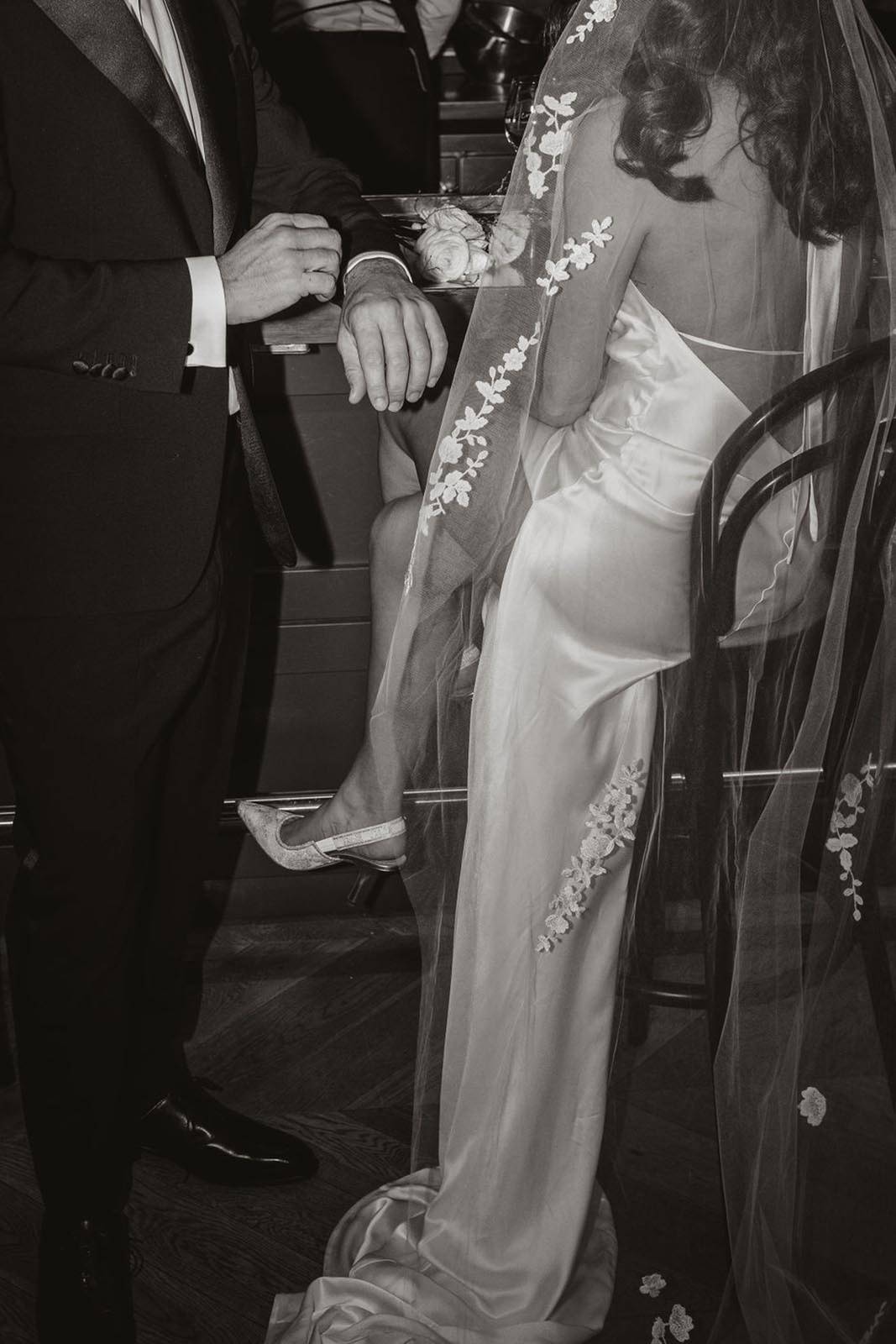 Bride and groom sitting at bar