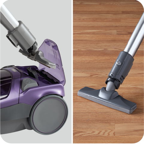 Vacuum cleaner components on hardwood floor, showing nozzle and canister details.