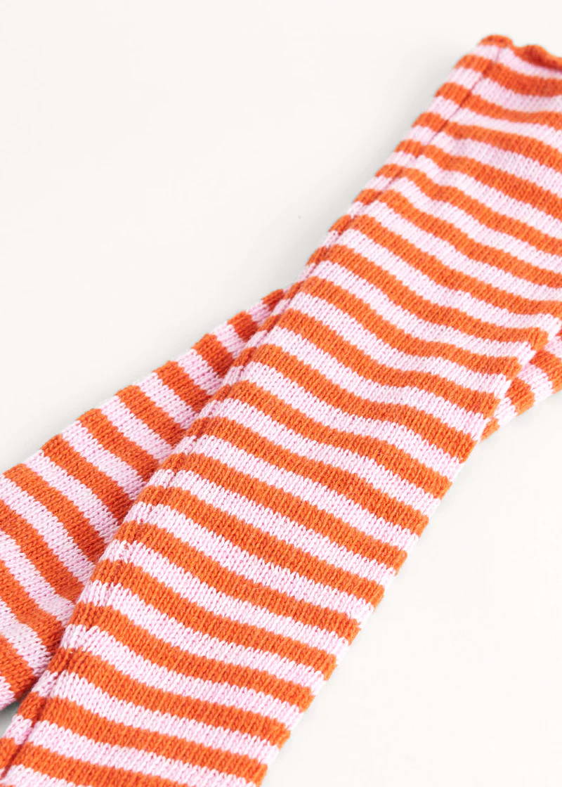 A pair of pink and orange striped wrist warmers