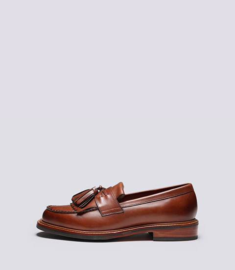 Morven Men's Brown leather loafers with a tassel detail, side view.