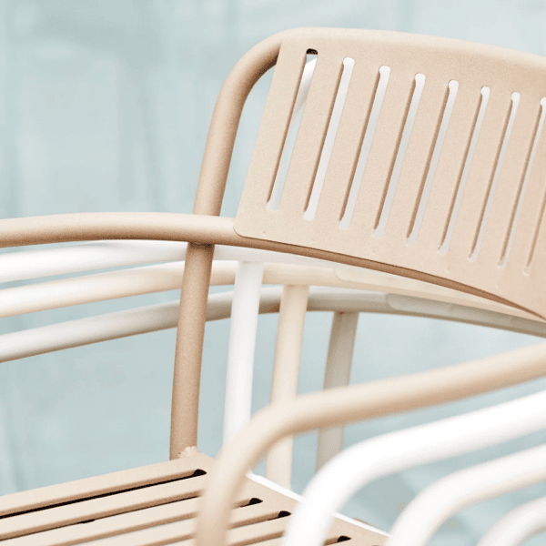 Close-up of powder-coated aluminum outdoor chair construction with slatted back and corrosion-resistant frame