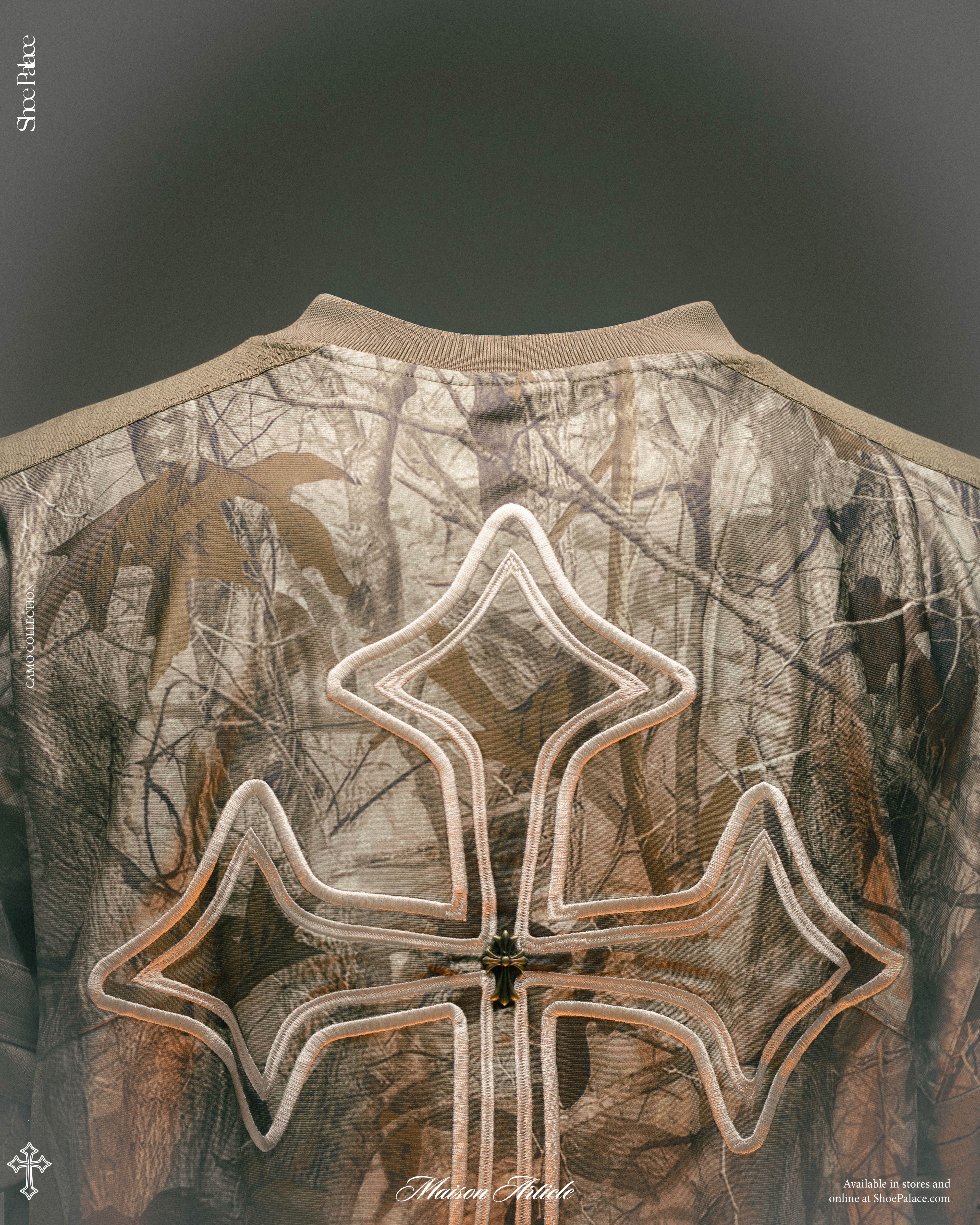 Back of a camouflage jacket featuring a large white emblem.