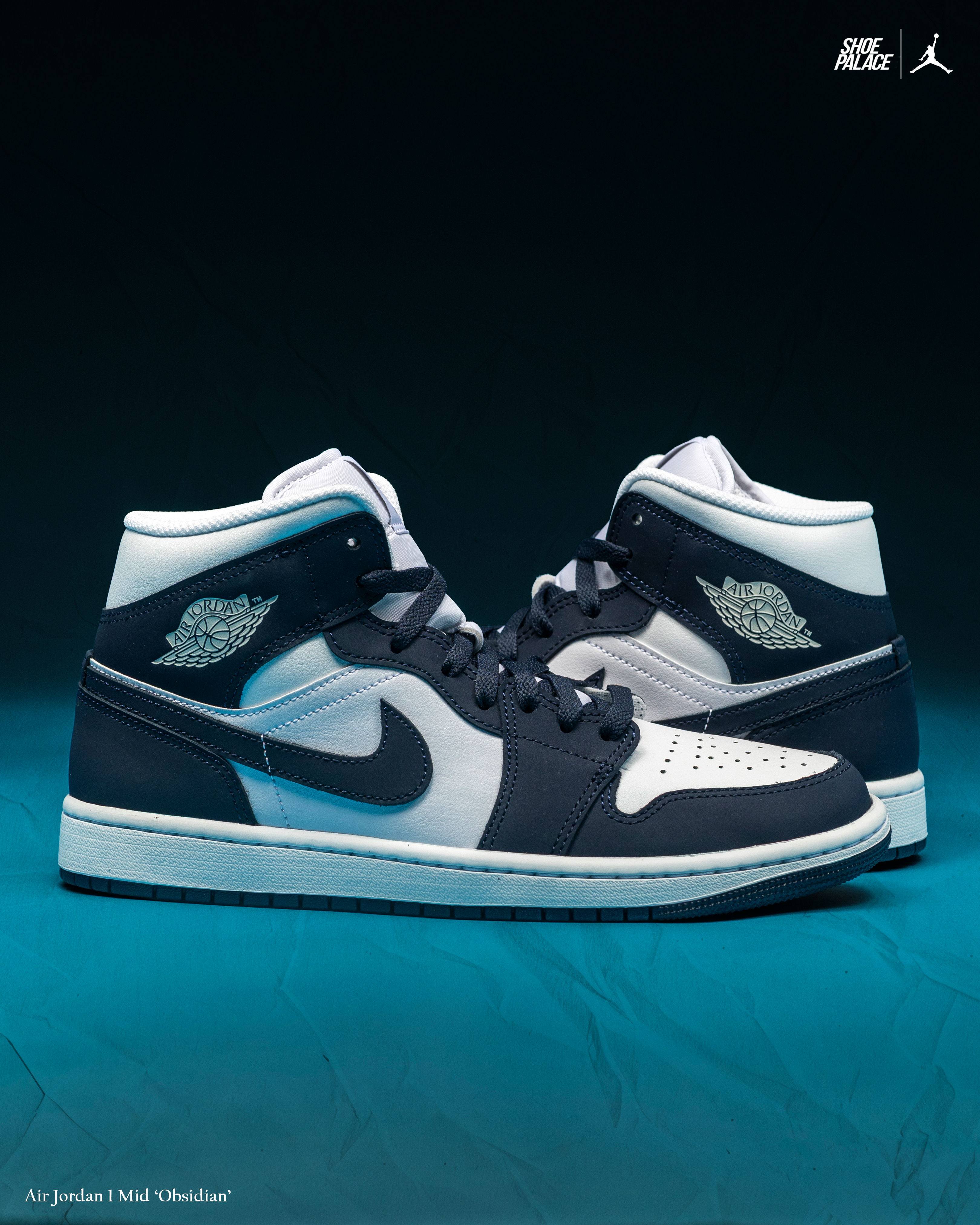 A pair of Air Jordan 1 sneakers in navy and white colors.
