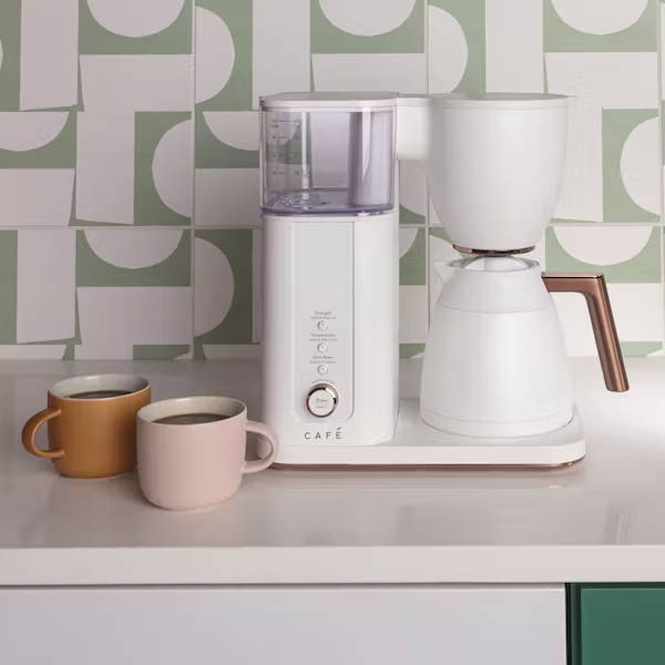 cafe matte white coffee maker on counter with mugs 