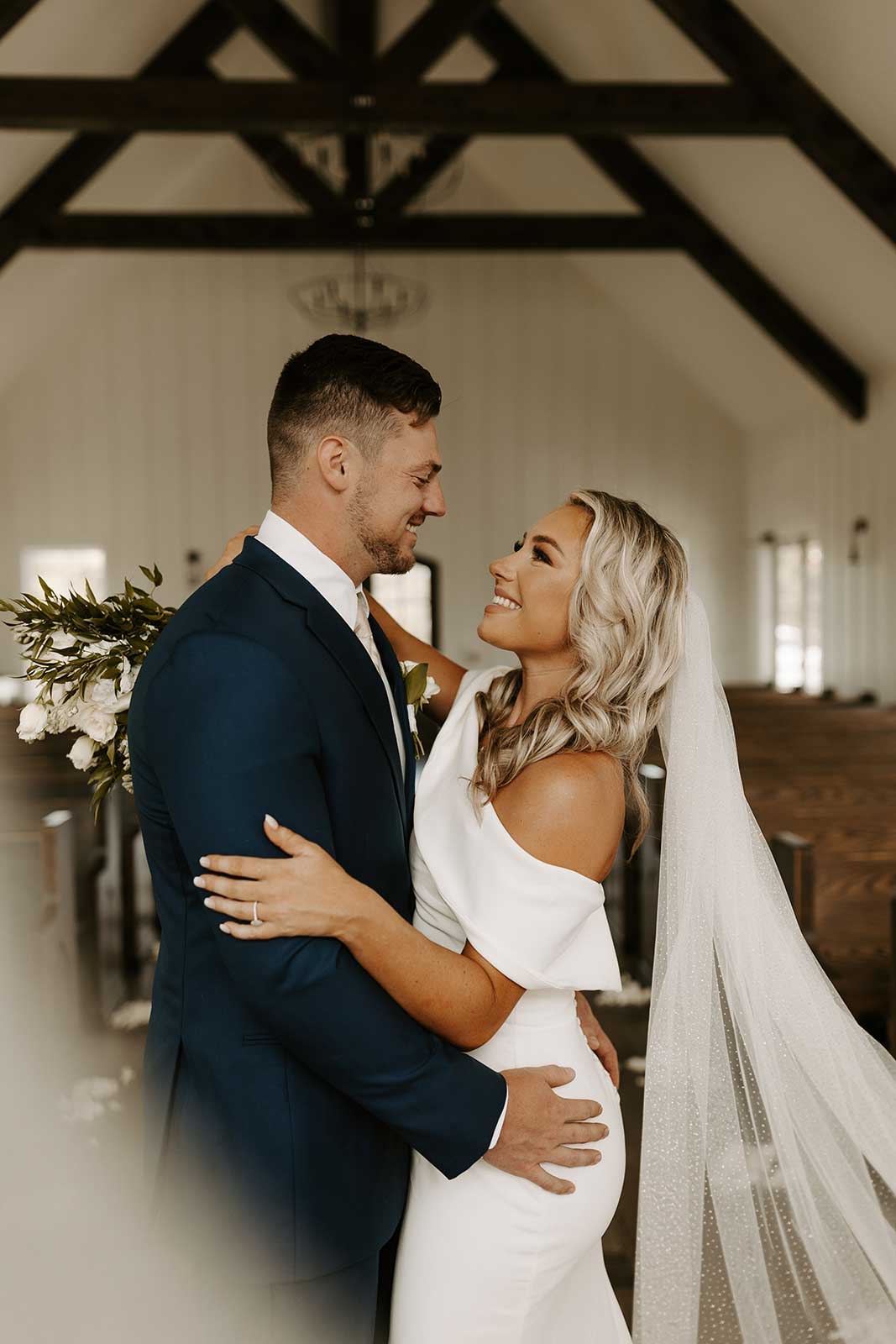 Bride and groom smiling together at wedding ceremony