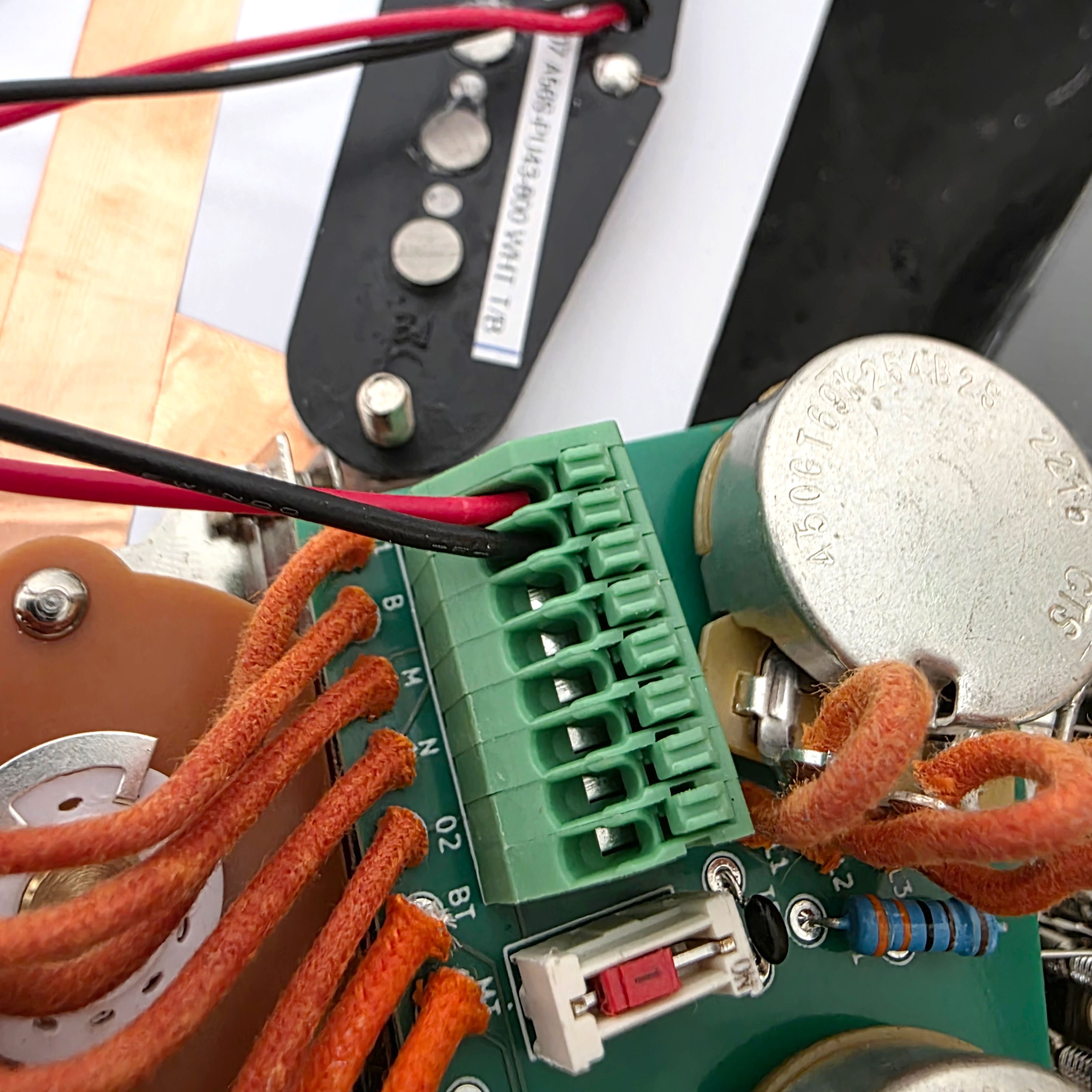 Close-up of a circuit board with wires and electronic components.