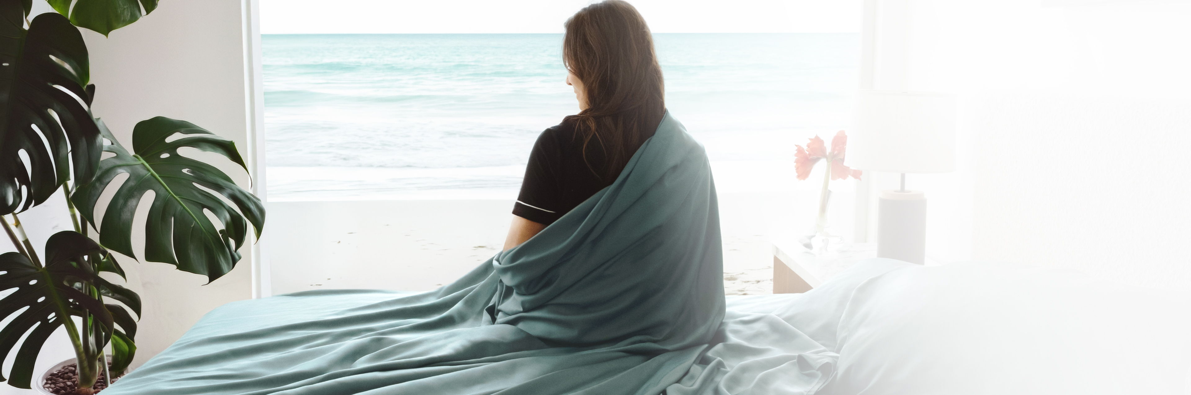 a woman on a bed with cariloha bedding