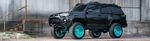 Side view Kealoha's black 2019 Toyota 4Runner lifted turquoise wheels winch bumper roof rack industrial building Conductor's Special 244K Spare Tire Delete featured customer install gallery photo 1