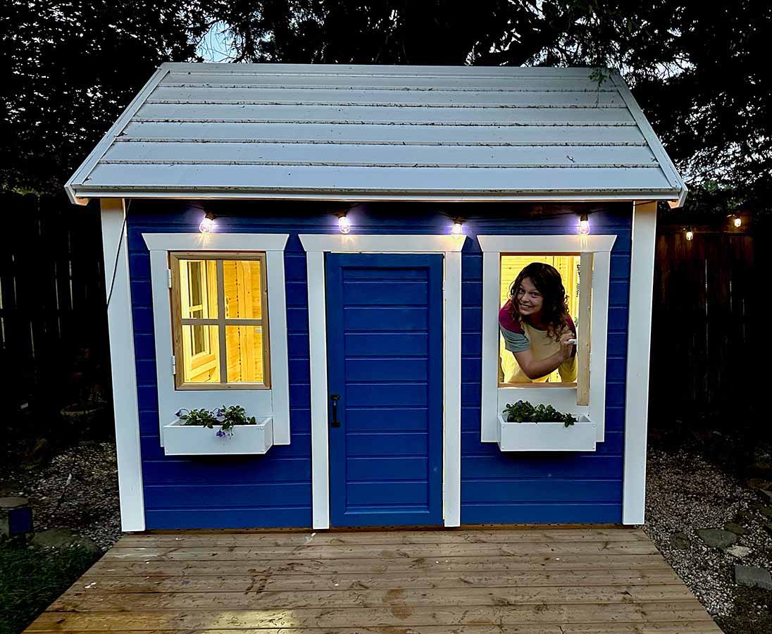 Blue and white Outdoor Playhouse with white Flower boxes and wooden terrace by WholeWoodPlayhouses
