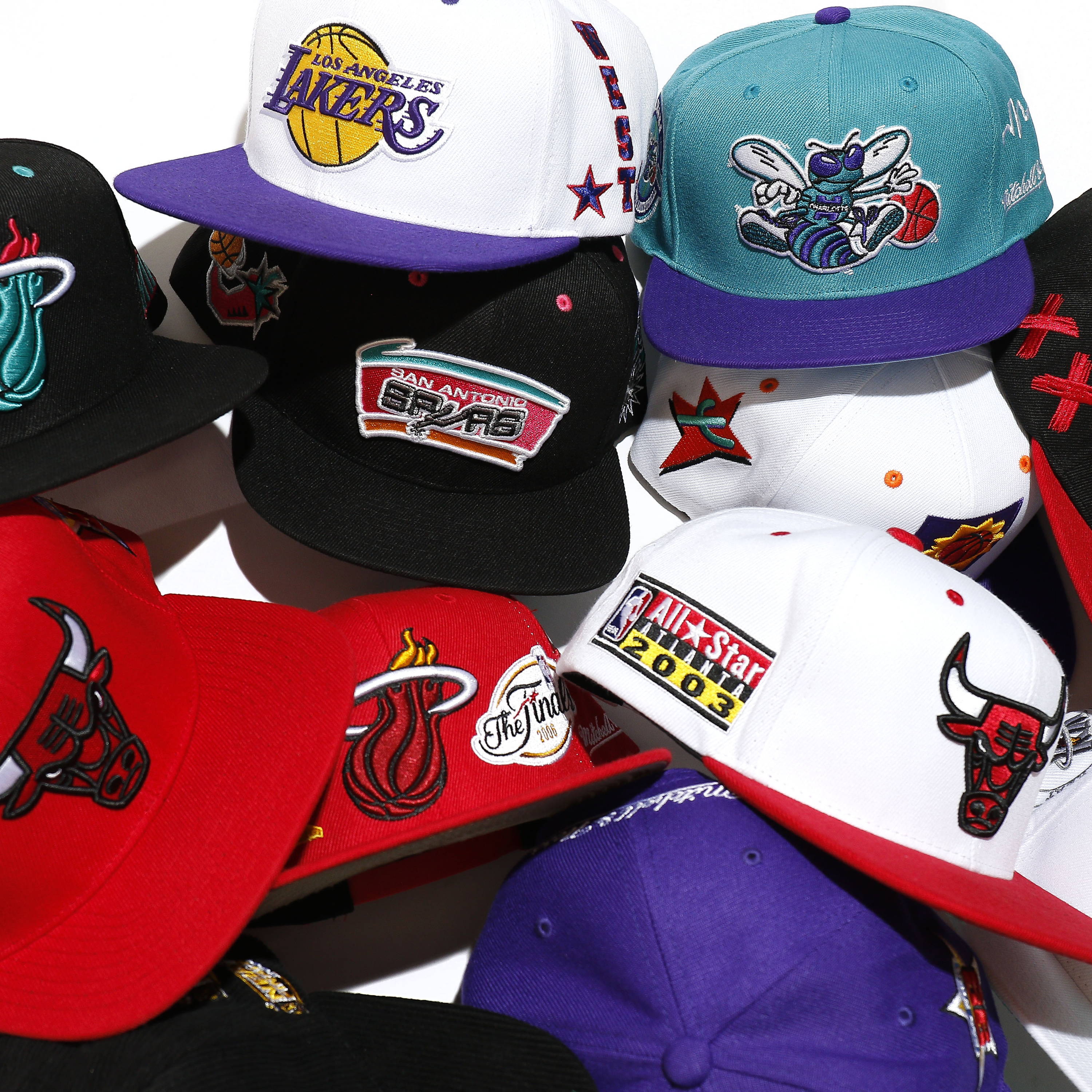 several mitchell & ness hats scattered