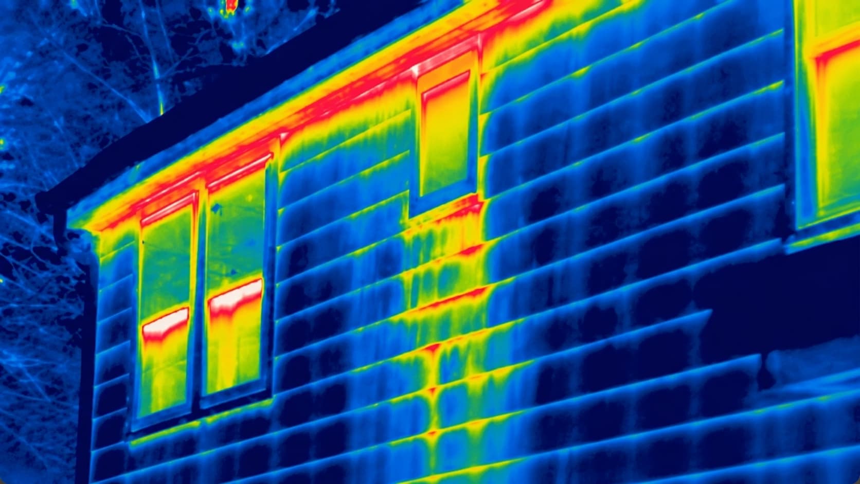Thermal inspection of a building showing heat loss and possible moisture pathways