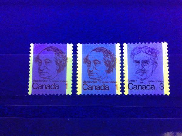Three tagged stamps of the 1972-78 Caricature Issue of Canada, as seen under ultraviolet light