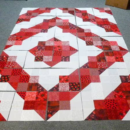 quilt blocks on the floor to demonstrate the web method for assembling quilt blocks