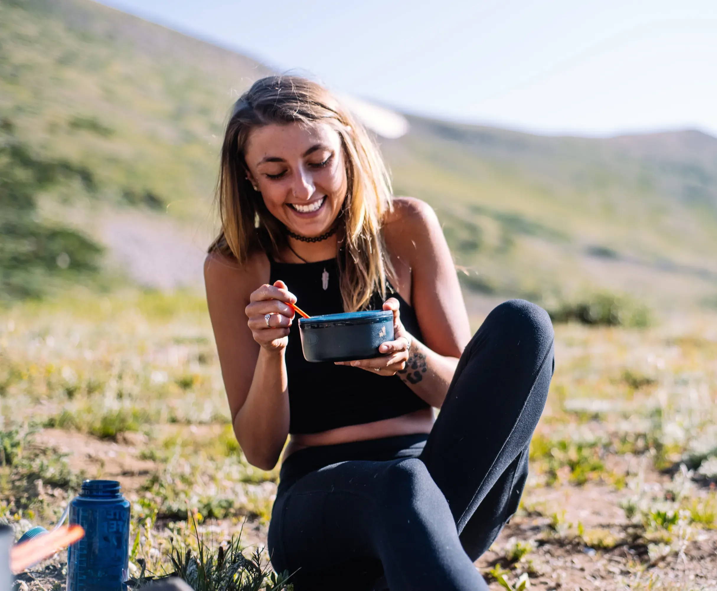 Woman eating soup in nature