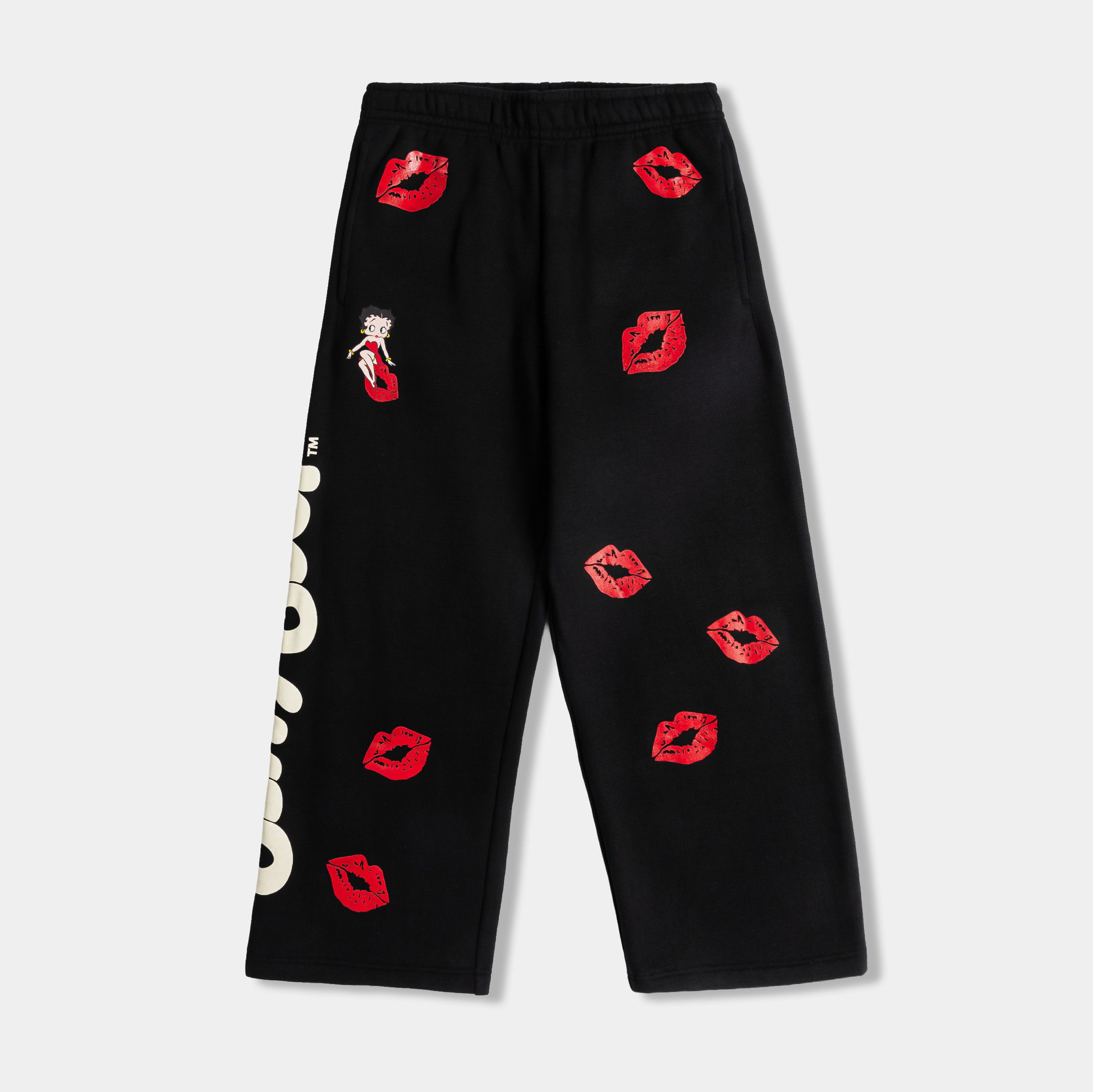 Black pants with red lip prints and white text.