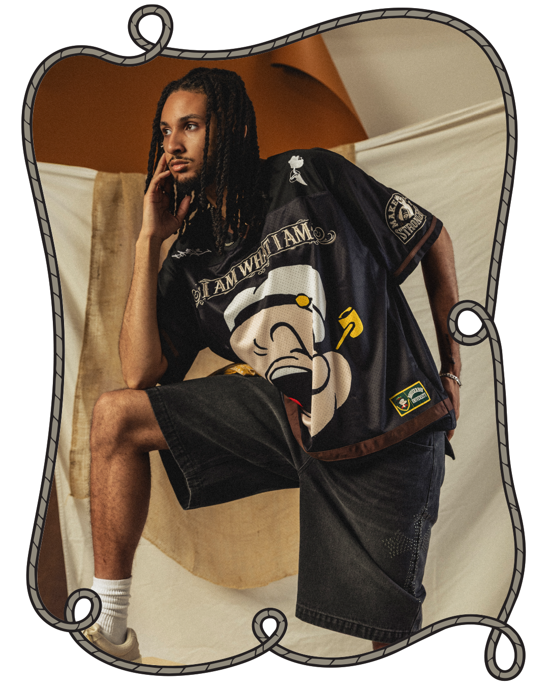 Person in Popeye shirt and shorts posing against a backdrop.