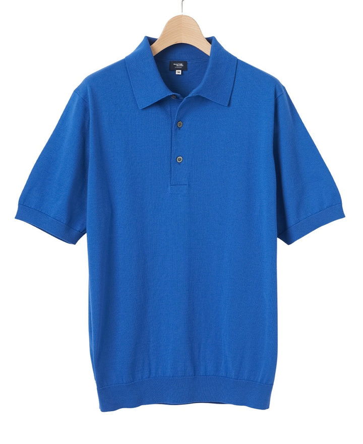 Blue short-sleeve polo shirt hanging on a wooden hanger.