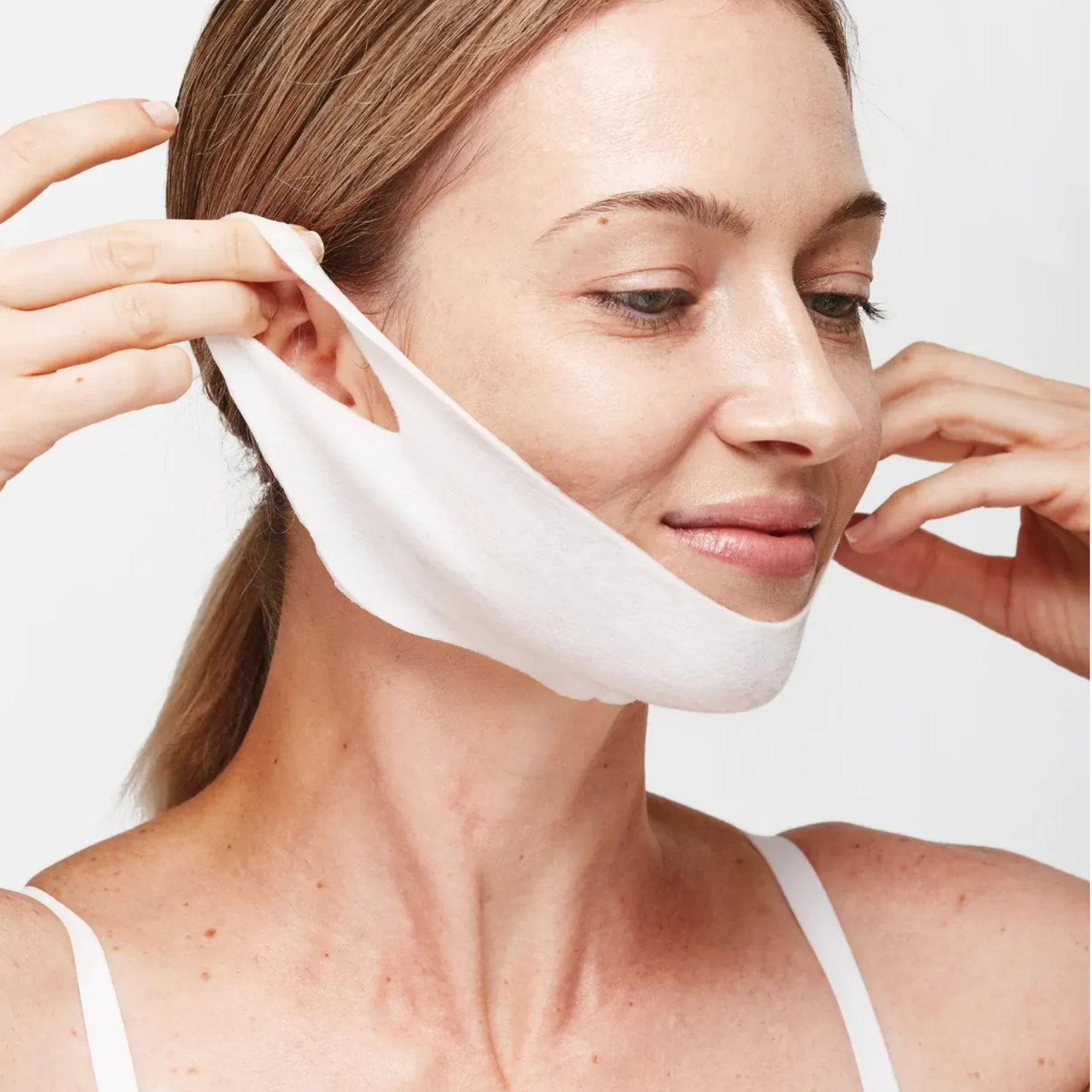 woman wearing the depology derma face sculpting mask to treat neck wrinkles