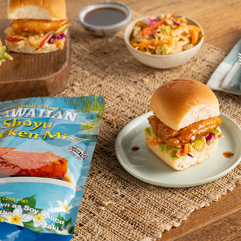 A plate with a chicken sandwich and a side of coleslaw.