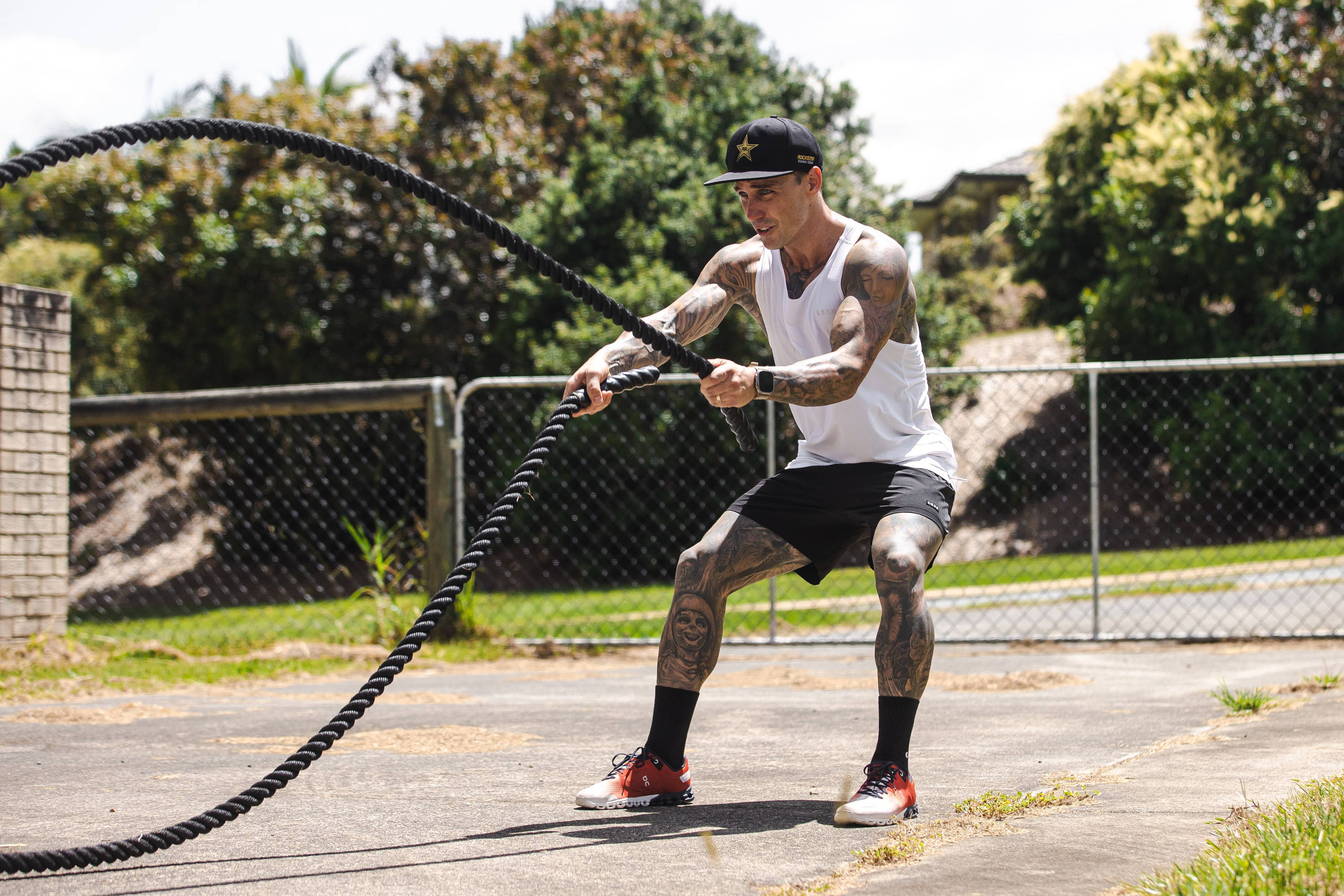 man using battle ropes