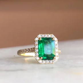 emerald ring with a pave halo