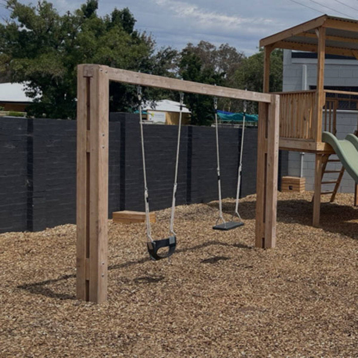 A wooden outdoor swings