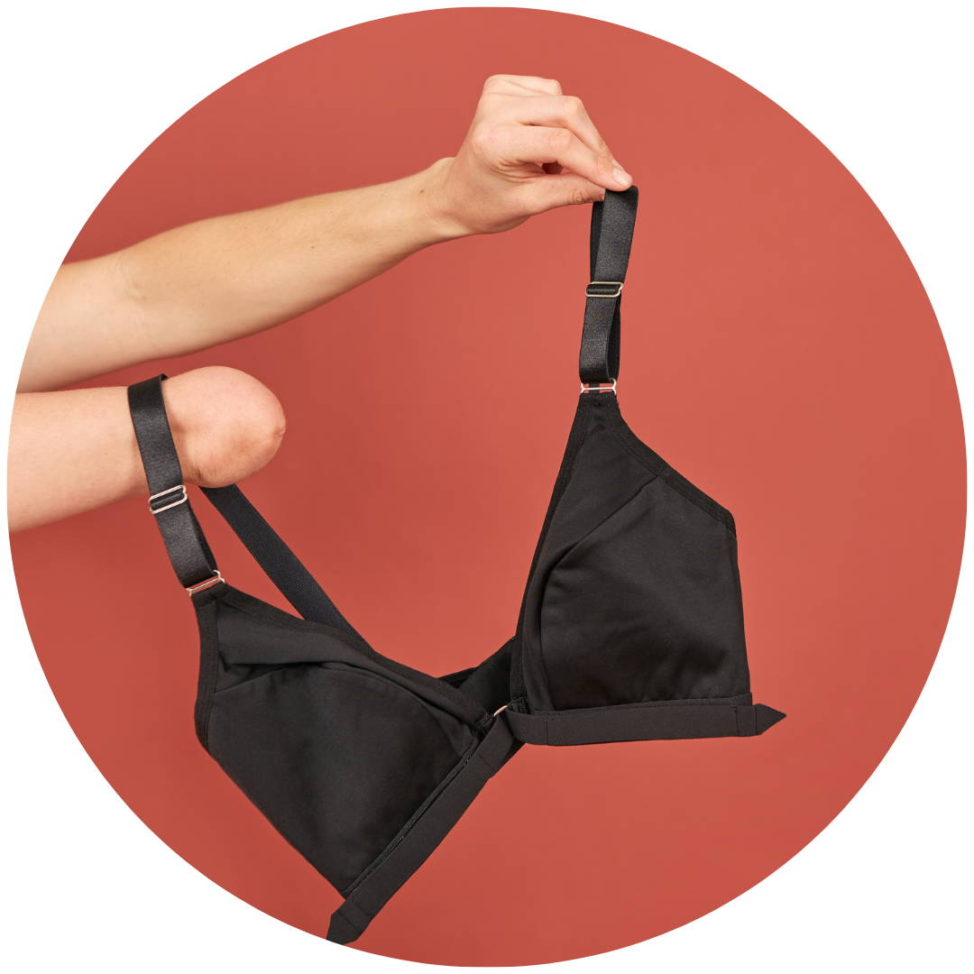 A black Springrose bra held by a disabled woman with a limb diference